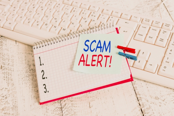handwriting text that says SCAM ALERT clipped on a notepad depicting AC Repair