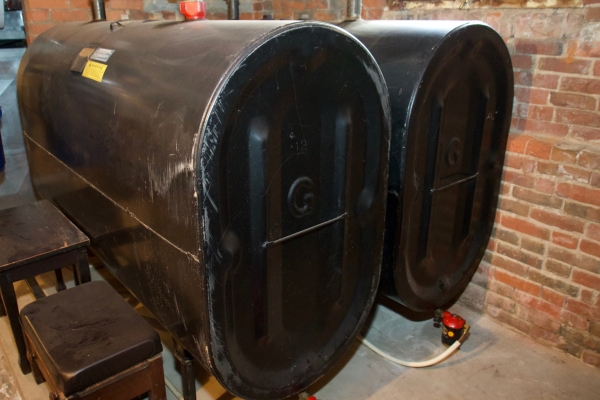 image of two black heating oil tanks installed in the basement