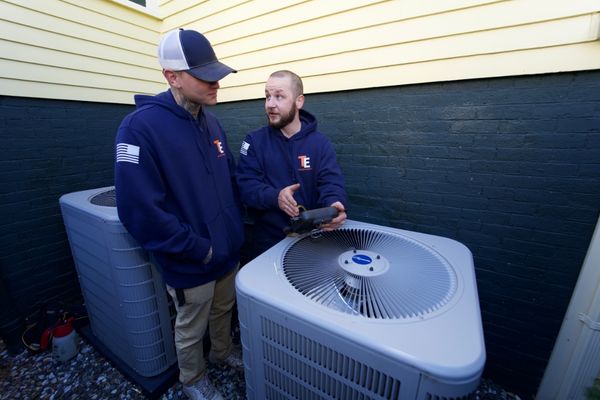 Taylor Energy HVAC technicians inspecting AC units