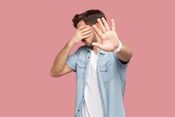 man covering his eyes and doing a stop sign depicting Why Weak Airflow Should Never Be Overlooked