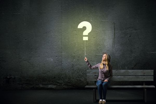 question mark like a balloon held up by a woman depicting FAQs About Air Conditioning Sickness