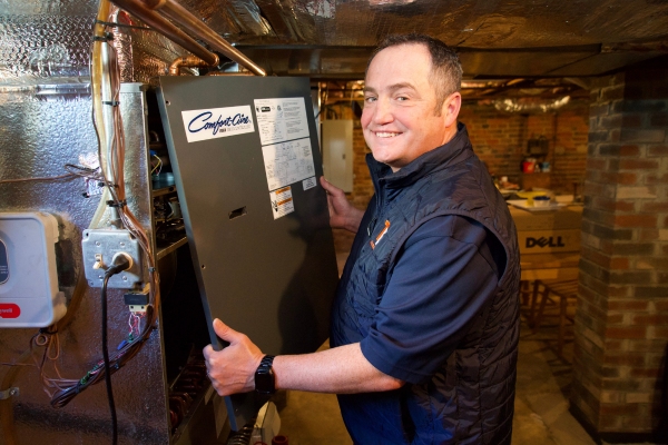 Windsor Locks, CT technician performing heating and furnace repair in a residential basement