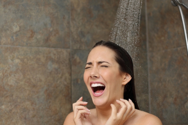woman screaming while showering due to water heating running out
